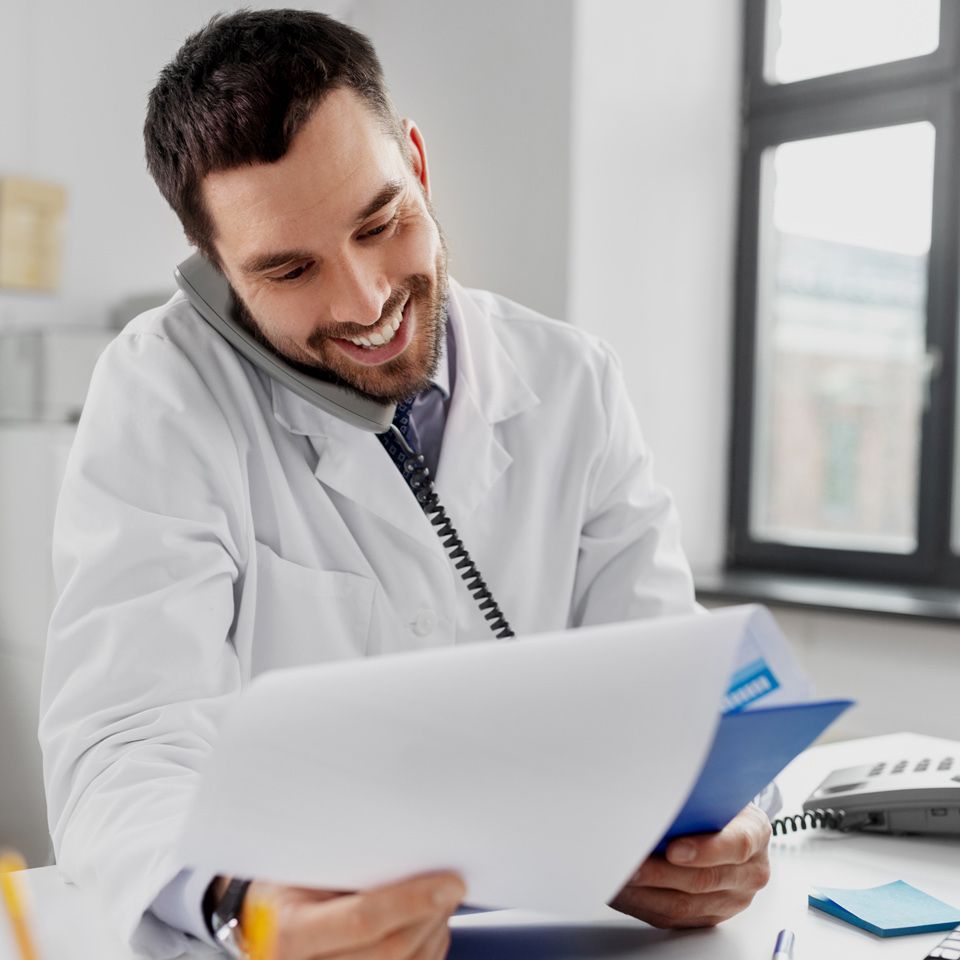Smiling Medicaid specialist reviewing paperwork for home care application assistance