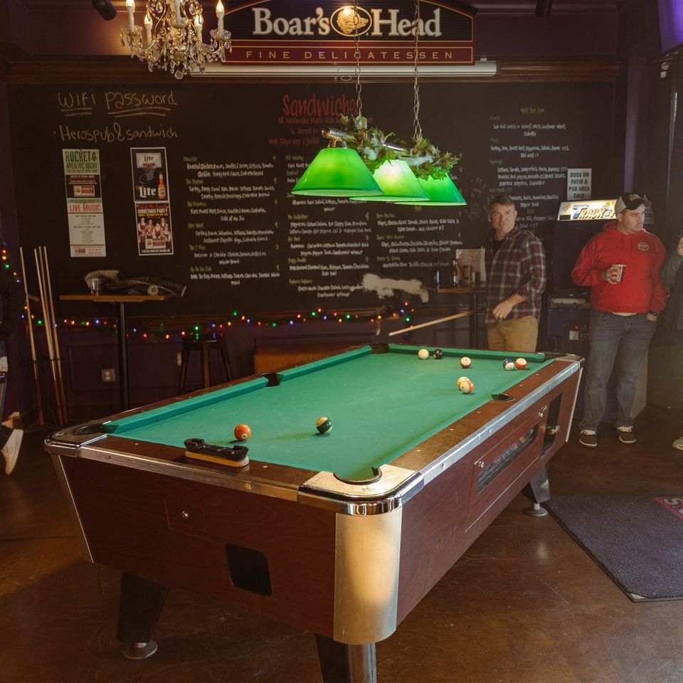 Groups conversing around pool tables
