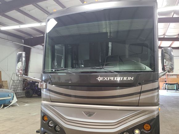 Front view of an RV with a professionally installed replacement windshield.