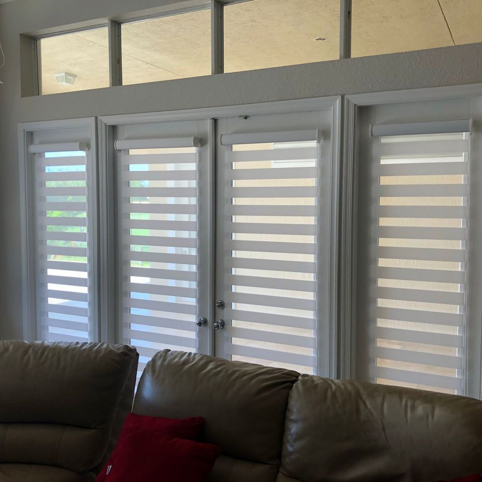 Dual zebra shades installed on patio French doors with transom windows above