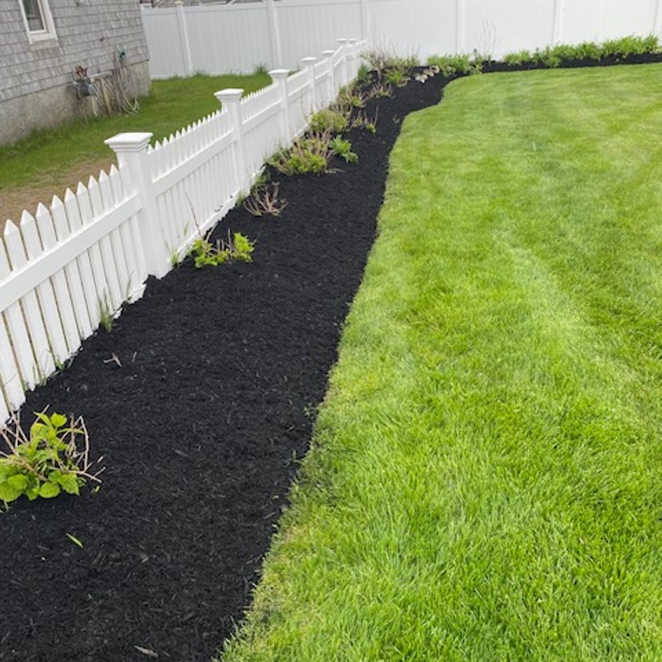 Sullivan mulch backyard fence after