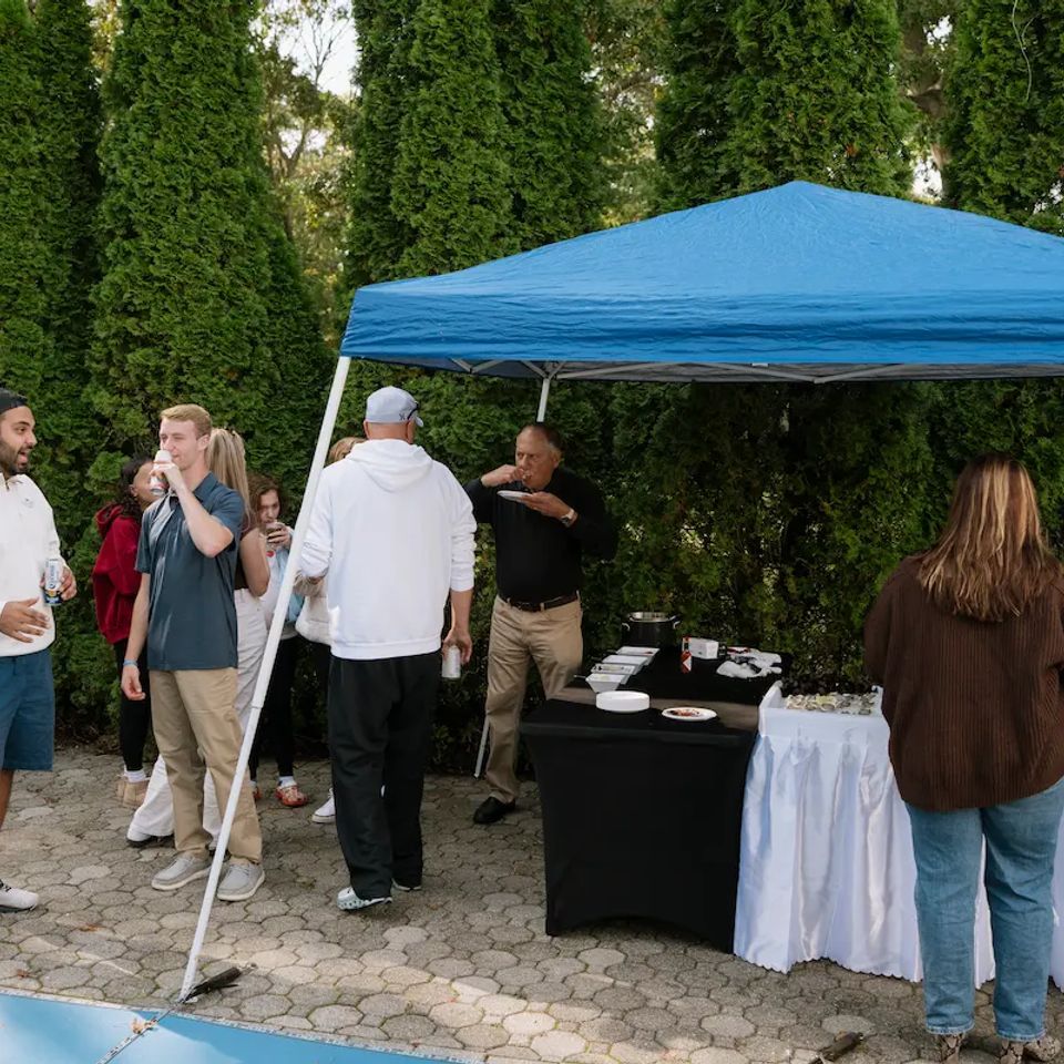 Group of people enjoying raw bar catering in a backyard for a party, by Shore2Shore Shucking of Long Island