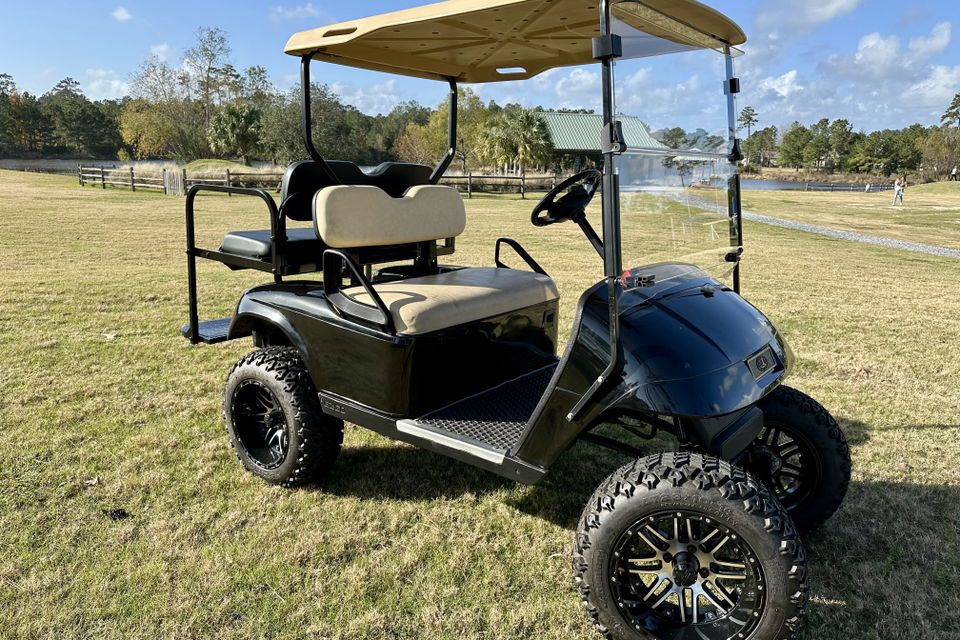 Custom black golf cart showcased on a golf course in Kenner, LA