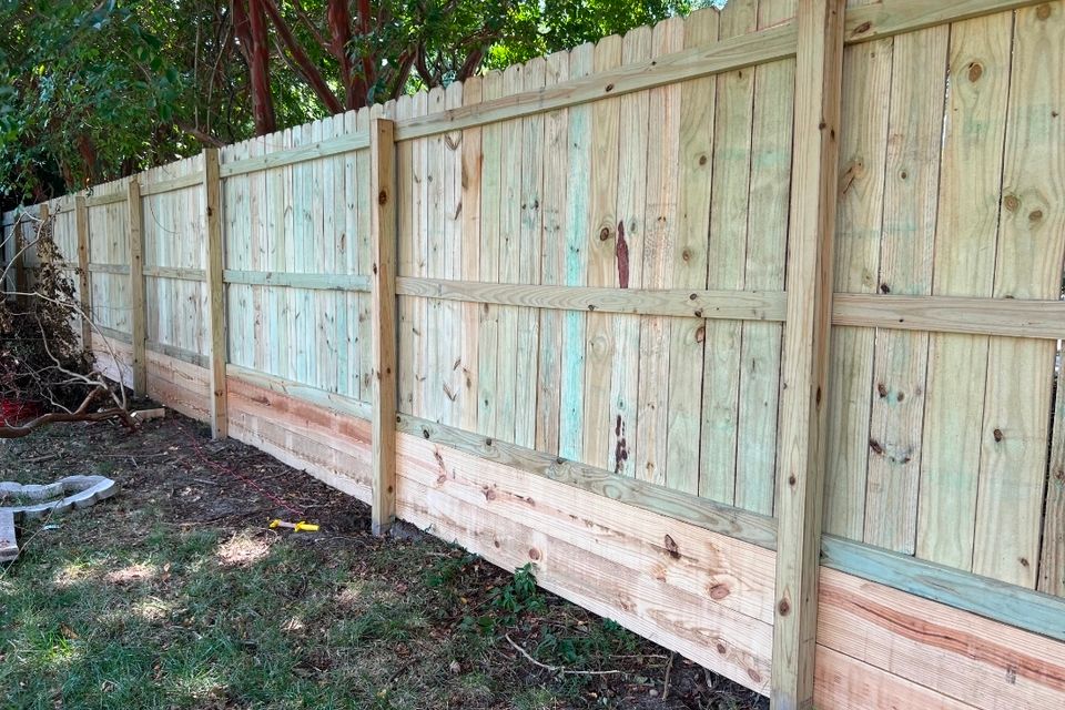 Wood privacy fence with kickboard installation along residential property line in Virginia Beach VA