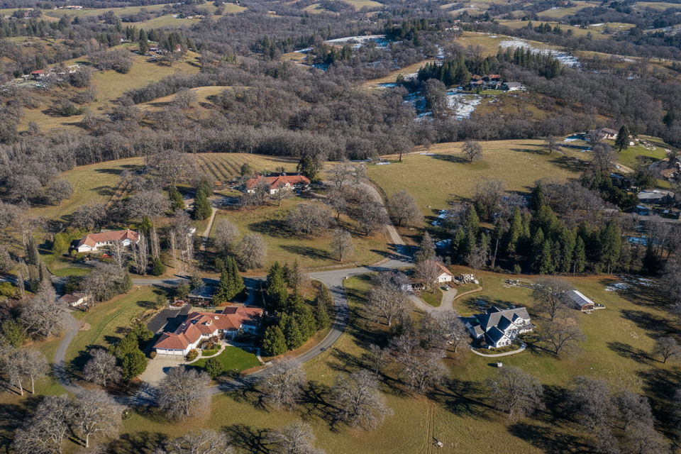 Aerial drone view of Penryn, CA, showing expansive residential estates and dense oak canopies served by the professional arborist team at Lyons Tree Service.