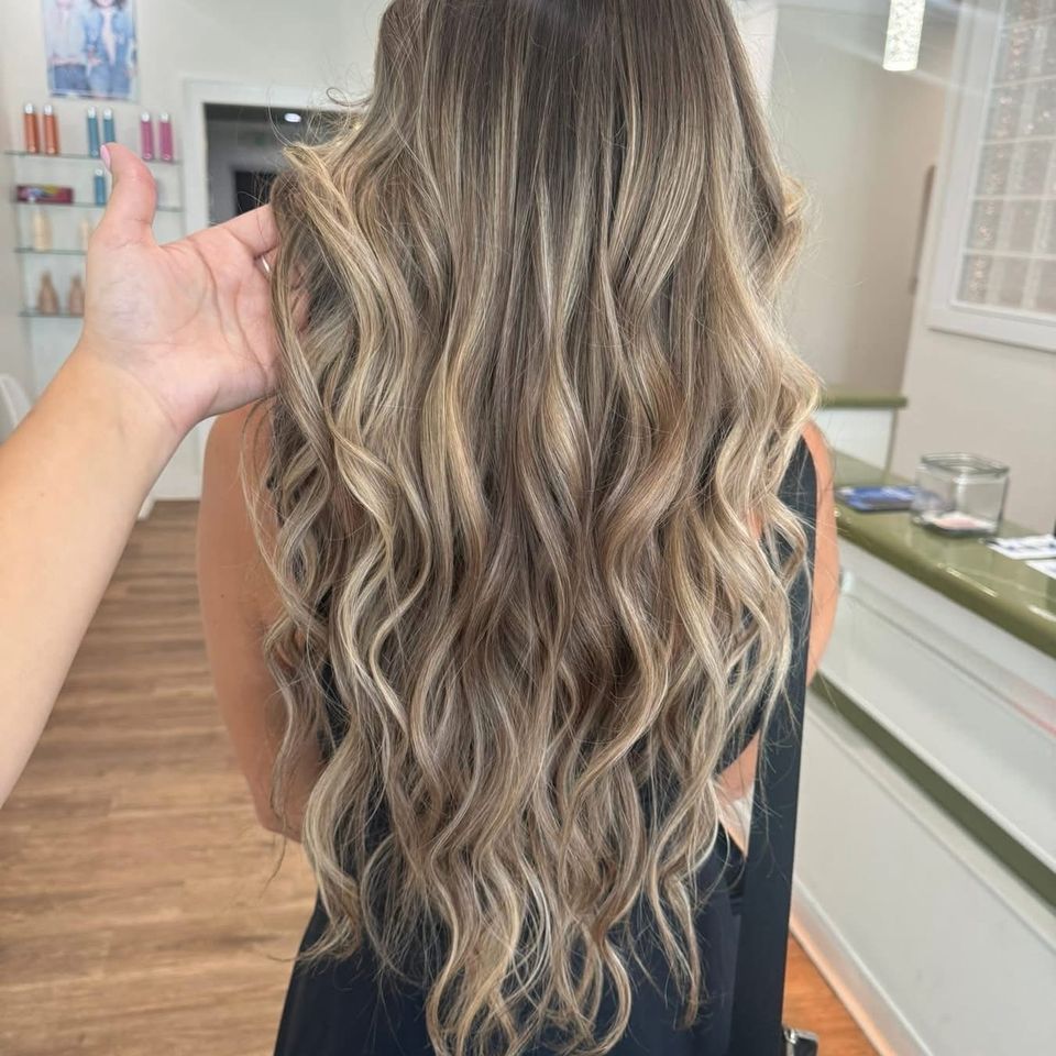 Long wavy bronde balayage with blended highlights after color and styling in Columbiana AL