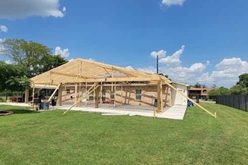 Framing spans the full patio footprint beside a spacious yard in Kingwood, TX