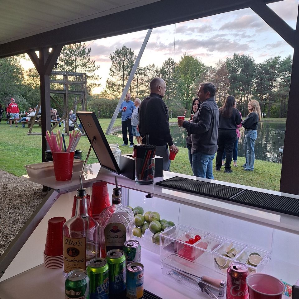 Close view of the full bar setup with liquor bottles, mixers, garnishes, and cups at the private party