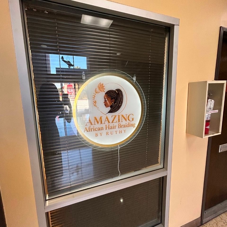 Amazing African Hair Braiding by Ruthy window sign at the salon entrance in Los Angeles CA