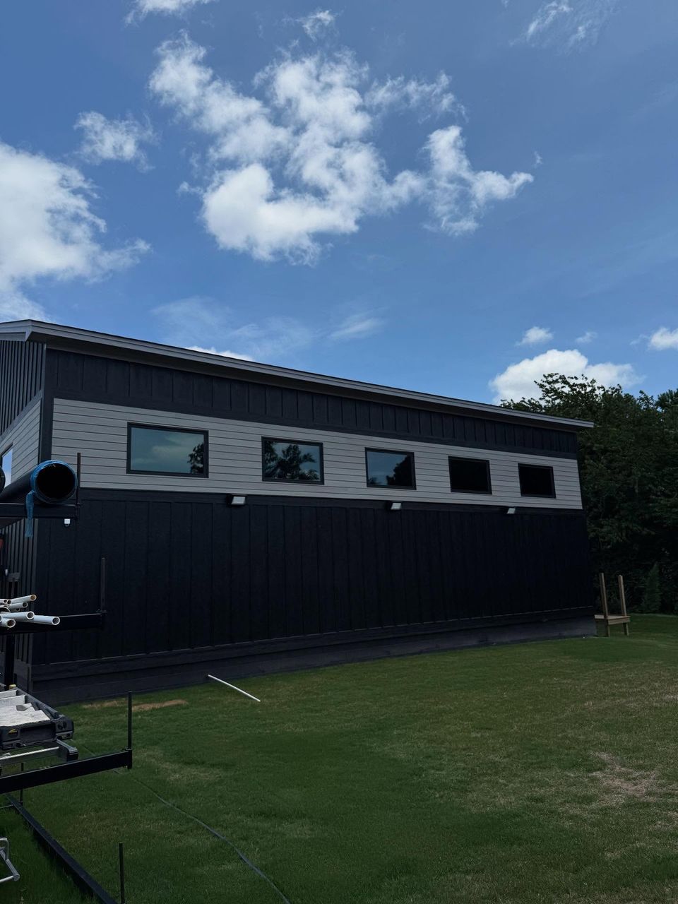 Black and gray modern building with a row of tinted clerestory windows after commercial tint in Moyock NC