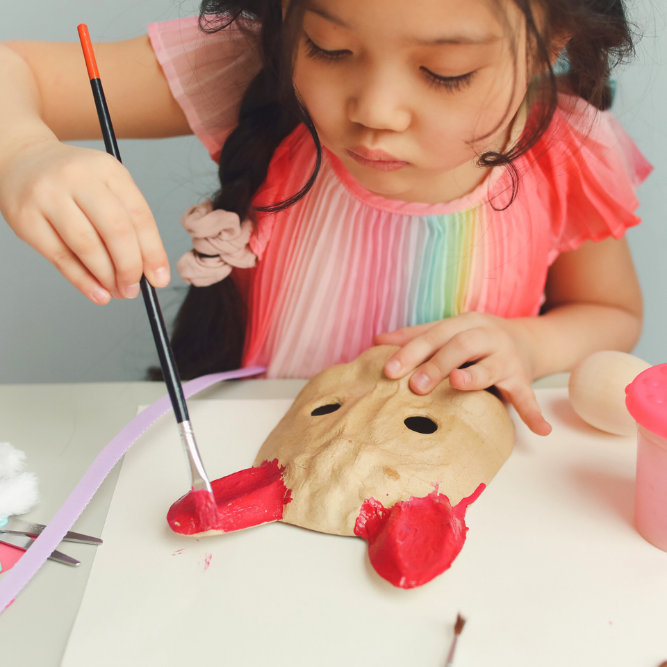K.B.T Kids Academy preschool little girl in pink painting mask