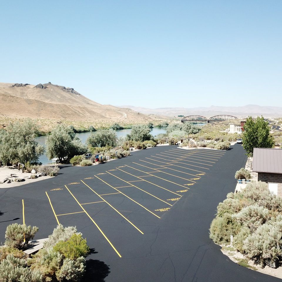 Parking lot with marking with bridge in background
