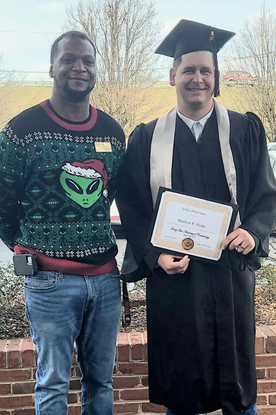 Beauty school graduate with certificate celebrating completion of program