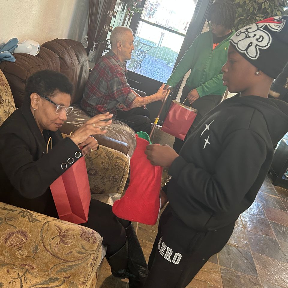 Christmas giving by group of youth at Hour Care transitional living home or group home in Houston, TX.