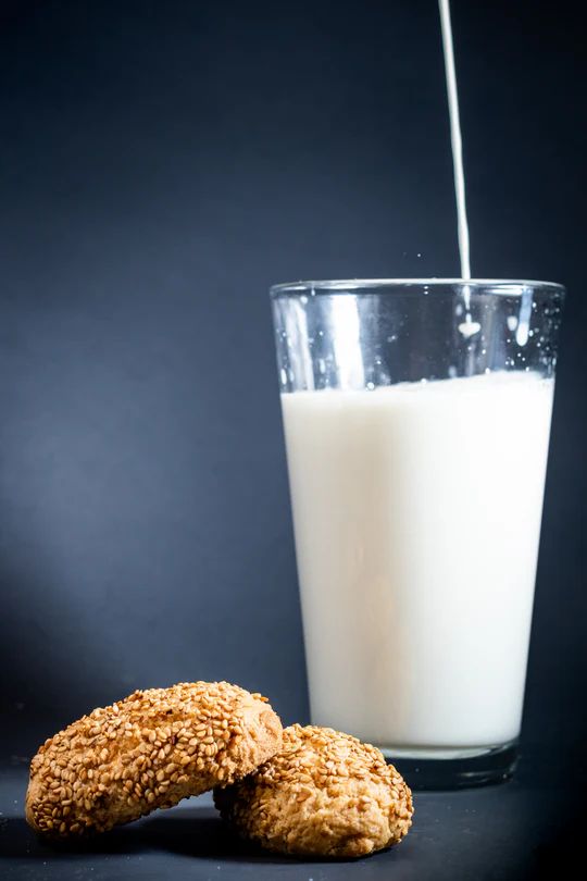 Cocoa Bliss cookies from Toni's Own Cookies next to a glass of milk