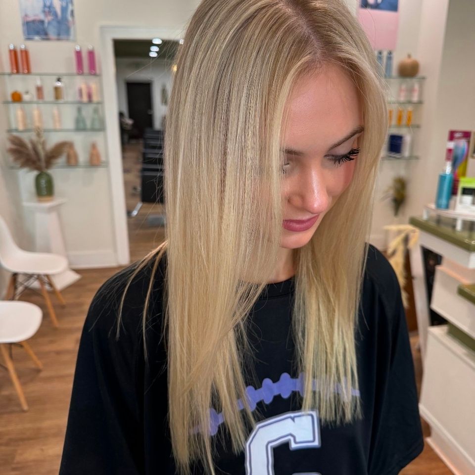 Long straight bright blonde hair with sleek finish after color service in Columbiana AL
