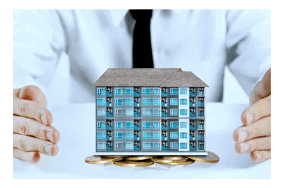 Insurance agent with model condo on desk