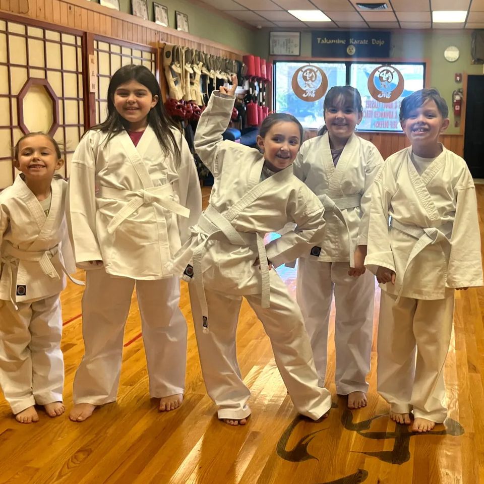 Kid students of Takamine Karate Dojo in Miller Place smiling for a group photo
