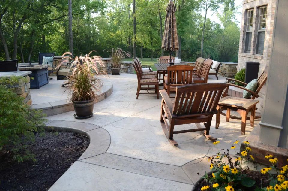 Stamped concrete patio with outdoor seating area and custom landscape design