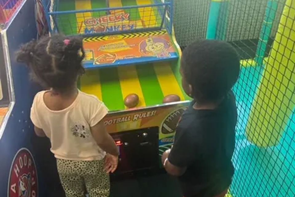 Children playing at Chuck E. Cheese Ball Toss