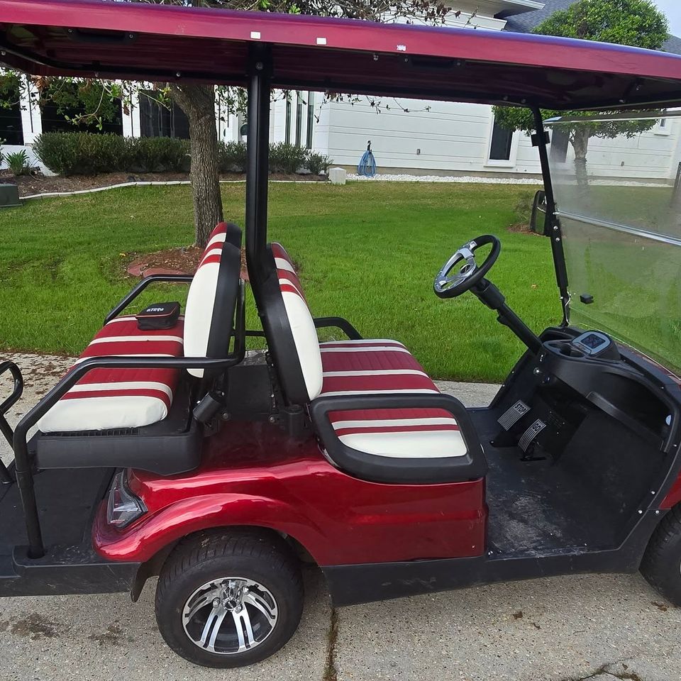 Red golf cart in driveway