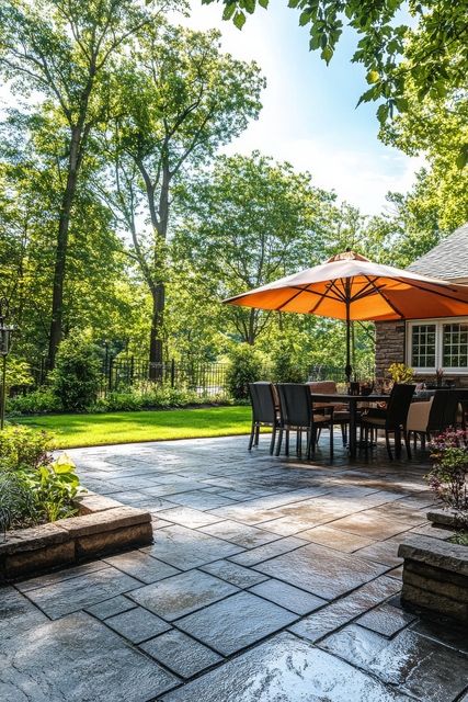 640 cozy outdoor dining area with an umbrella surrounded by greenery in a serene backyard setting
