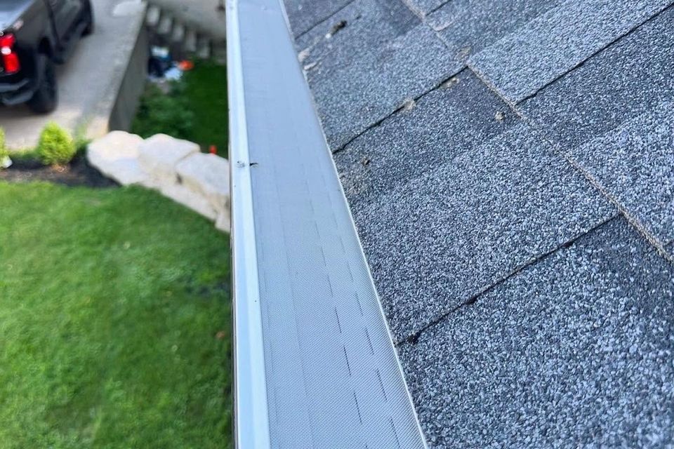 Newly installed gutter guard running along a shingled roofline in Tillsonburg Ontario