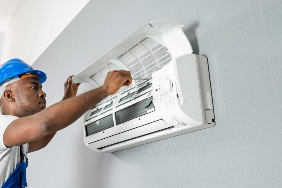 Technician repairing air conditioner happy young african male technician 870x580