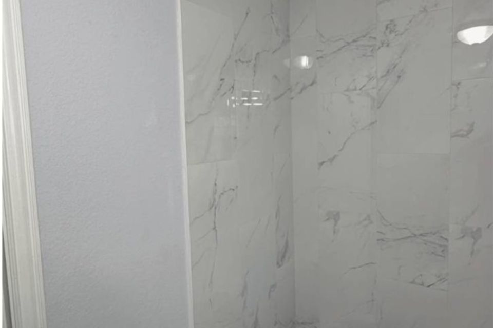 Completed bathtub tile surround installed during bathroom remodel in Spring Texas