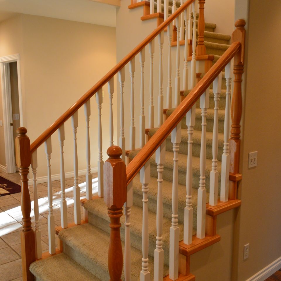 Detail of oak newel post and balusters on a custom home staircase