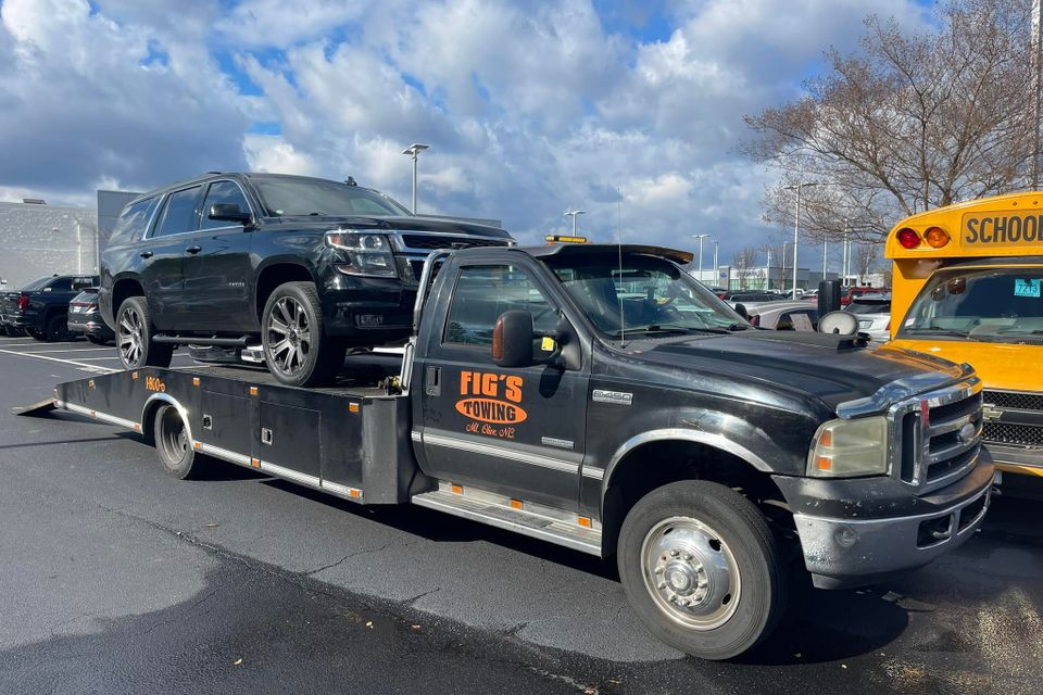 Figs towing black truck