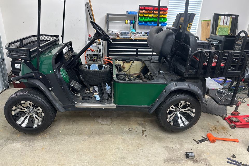 Green golf cart with upgrade wheels and tires by NGC