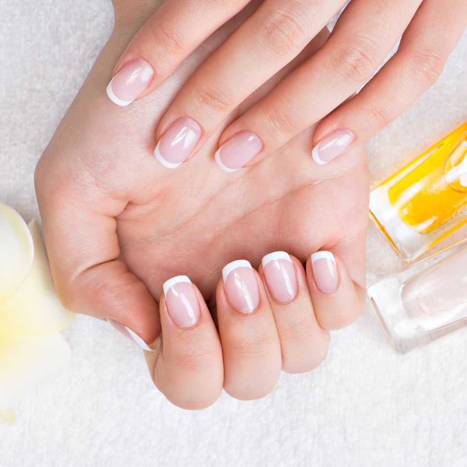 Woman nail salon receiving manicure by beautician beauty treatment concept