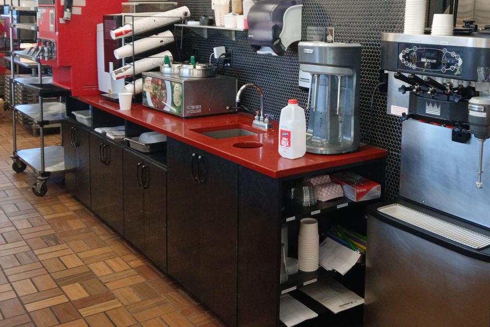 Custom cabinetry installation in a coffee shop by Ultimate Kitchens.