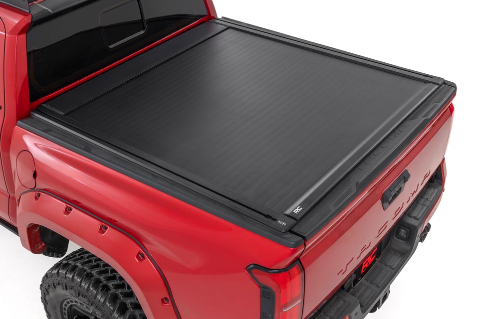 Red Tacoma with bed cover