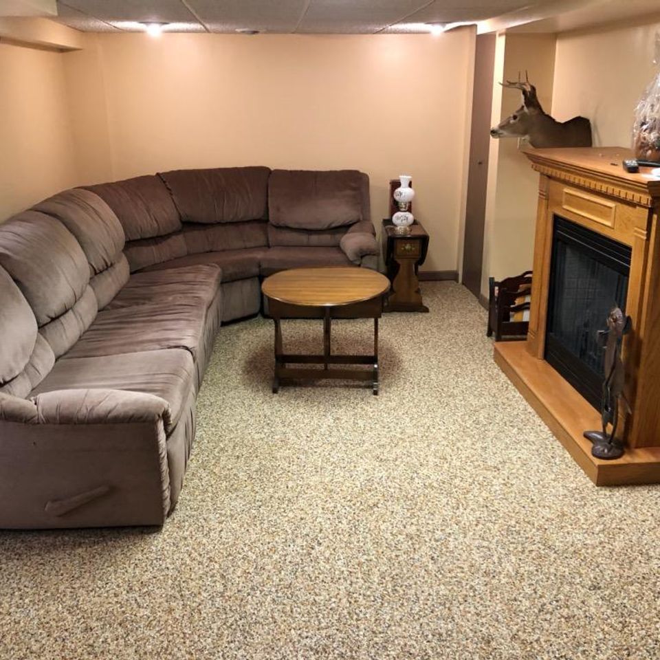 Basement living room with an EverStone decorative stone flooring system.