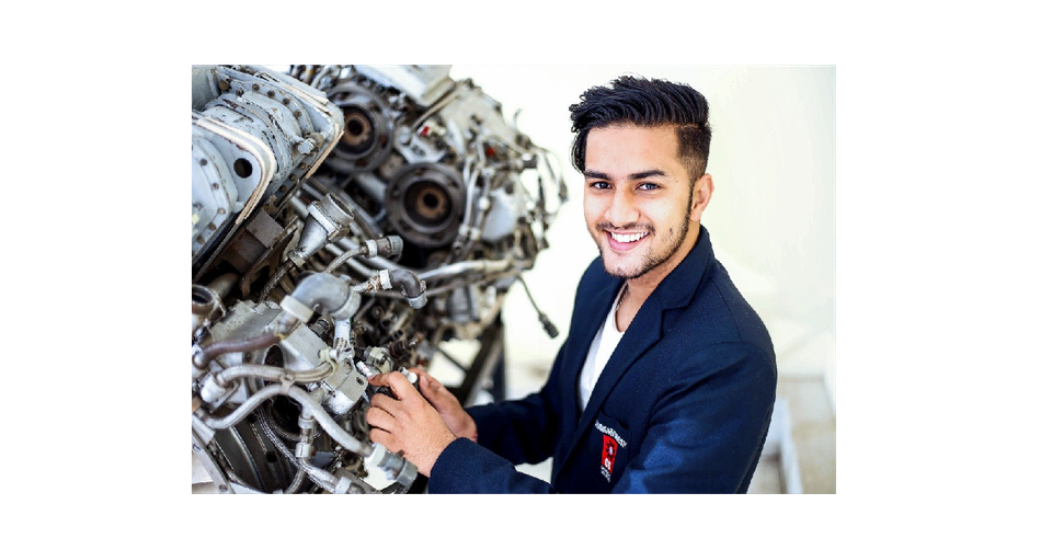 Image of a mechanic next to a complex engine configuration.