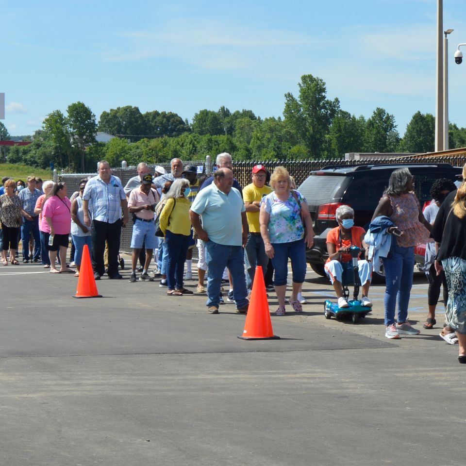 Crowds gather in a long line to enter the casino