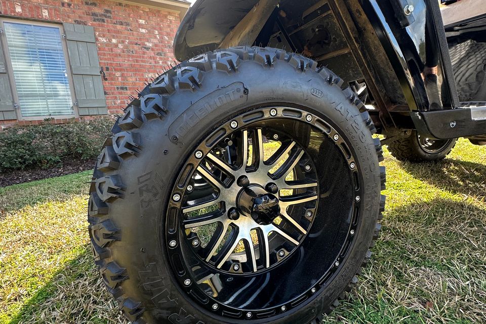 New custom wheels and tires on a black golf cart