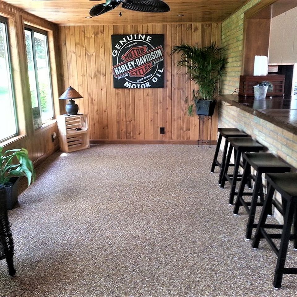 Finished basement entertainment area featuring an EverStone decorative stone flooring system.