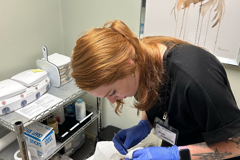 Esthetician student performing facial treatment in skincare training program