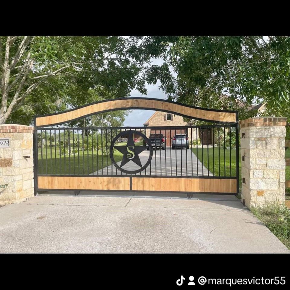 Custom iron driveway gate with wood accents built by Marquez Welding in Houston