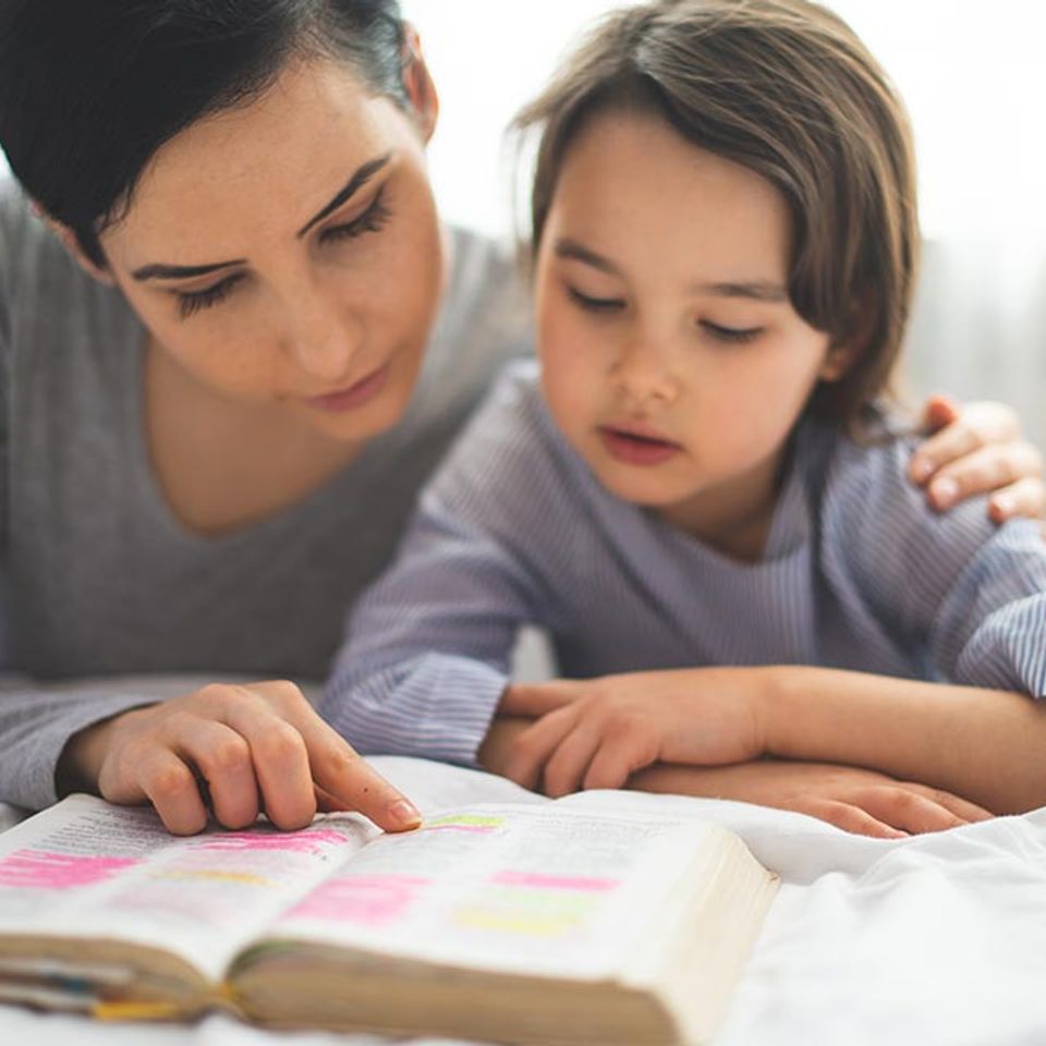 Child and Mother Reading Bible