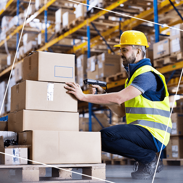 Man scanning box in warehouse with hardhat
