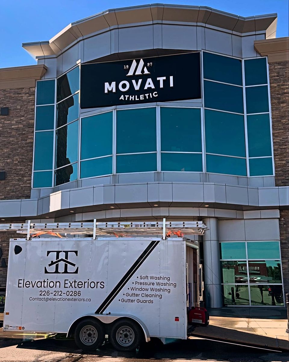 Elevation Exteriors trailer parked outside a fitness club for a commercial window washing job
