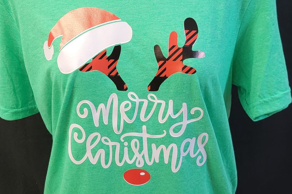 "DTF Direct-to-Film" example from SaRi's Creations - "Merry Christmas" with antlers on a green t-shirt