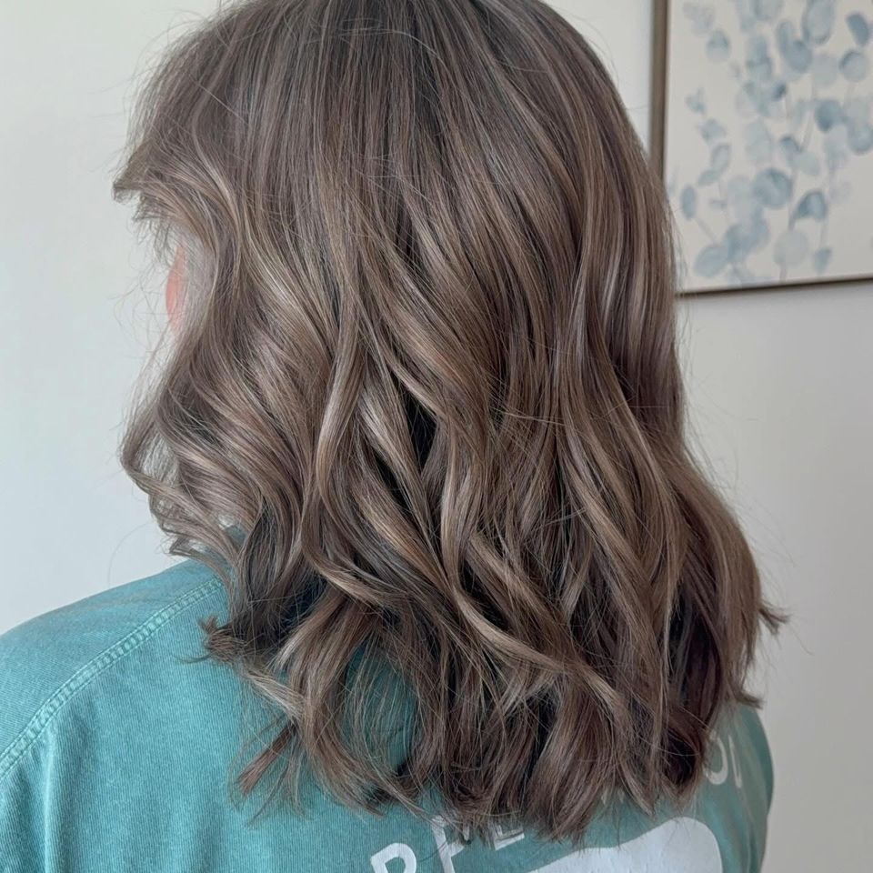 Medium wavy ash brown hair with soft highlights after color and styling in Columbiana AL