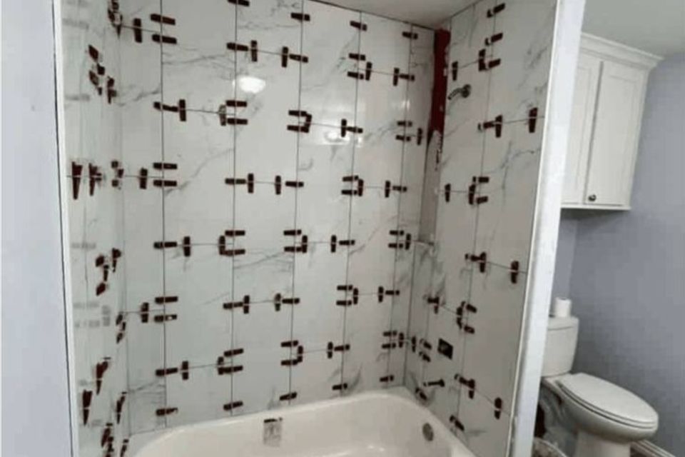 Tile installation in progress for bathtub surround during Spring TX bathroom renovation