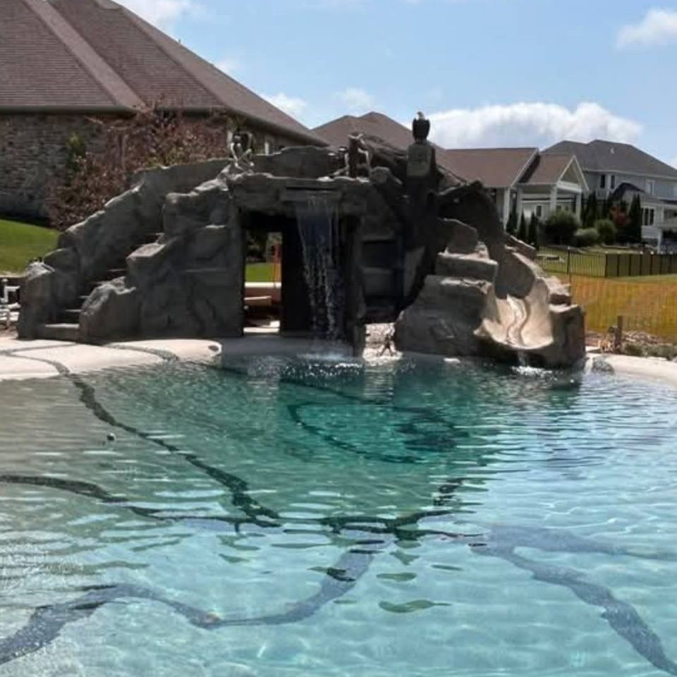 ClifRock stonework surrounding a swimming pool and waterfall feature.