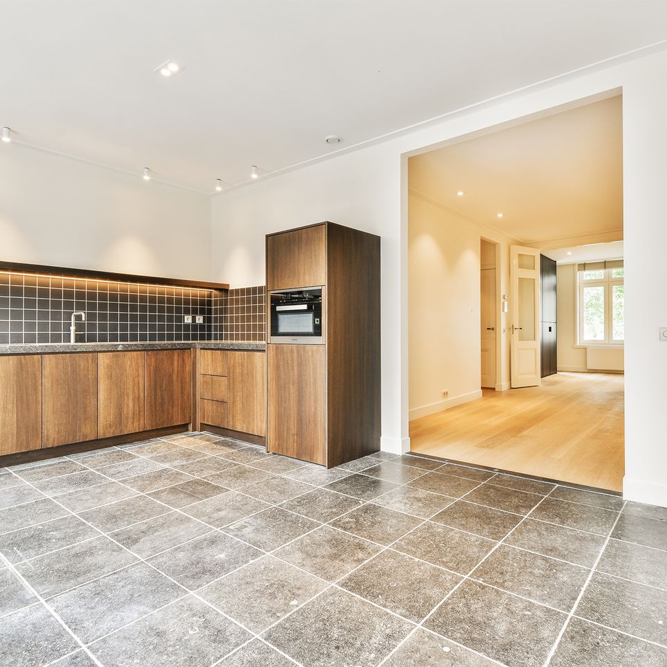 Vecteezy a kitchen with tile flooring and wooden cabinets 50422982 brighter